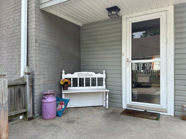 view of exterior entry with a patio