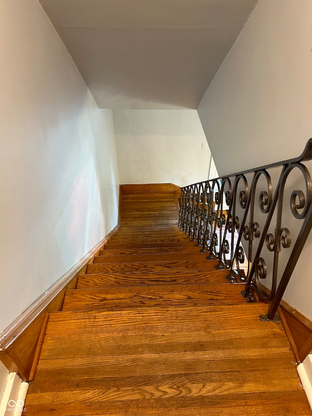 stairway featuring hardwood / wood-style floors