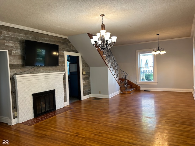 unfurnished living room with ornamental molding, dark wood-type flooring, and a notable chandelier