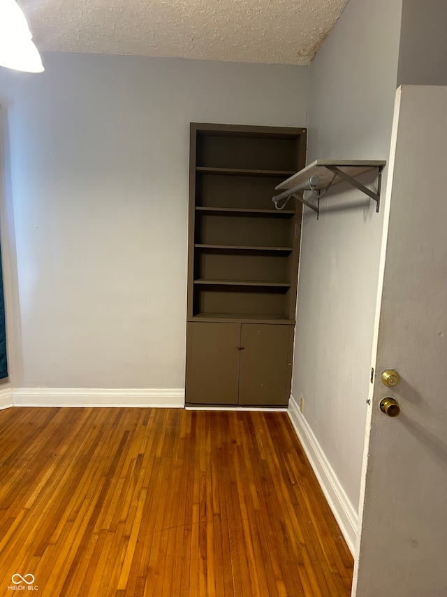 spacious closet featuring dark hardwood / wood-style flooring