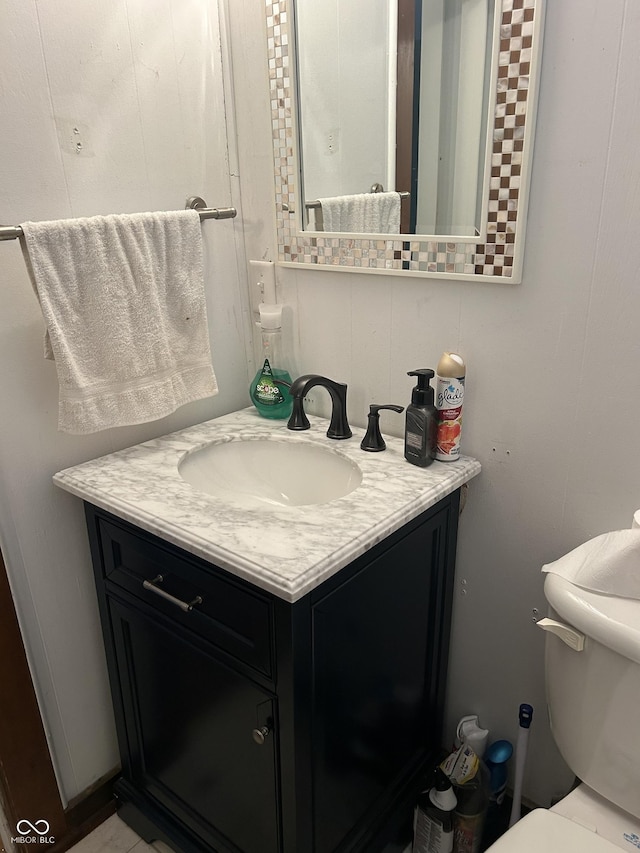 bathroom featuring vanity and toilet