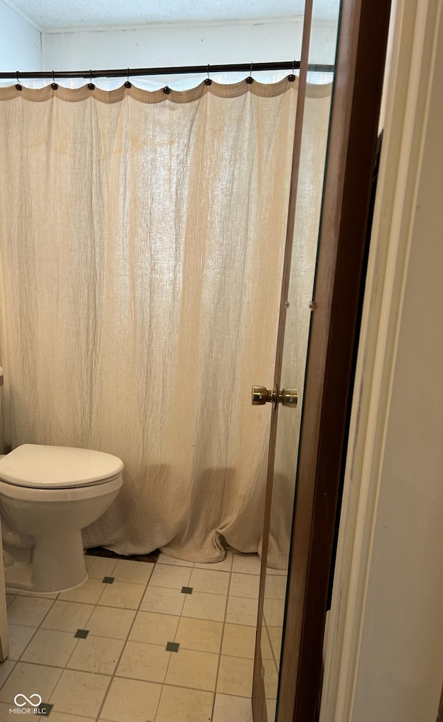 bathroom with tile patterned floors and toilet