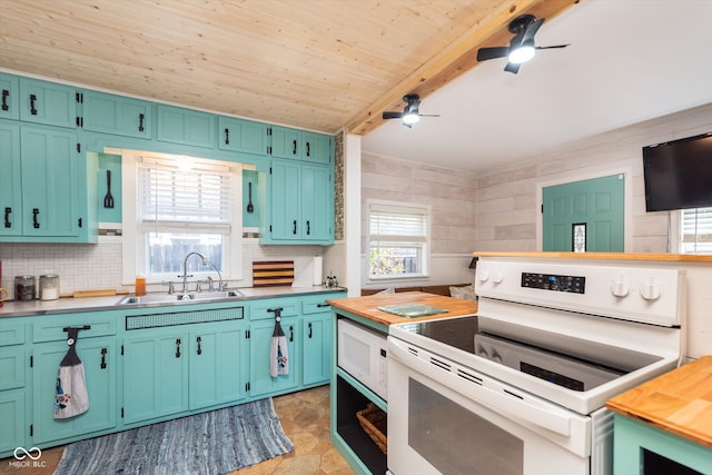 kitchen with butcher block countertops, beamed ceiling, white appliances, and sink