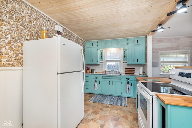 kitchen with white appliances, sink, wooden ceiling, and wood counters