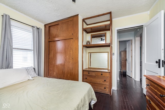 bedroom featuring a textured ceiling, dark hardwood / wood-style floors, and crown molding