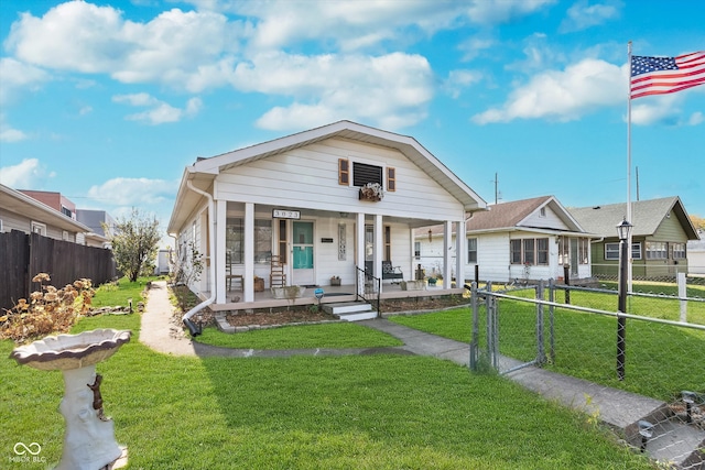 bungalow-style house with a front lawn and covered porch