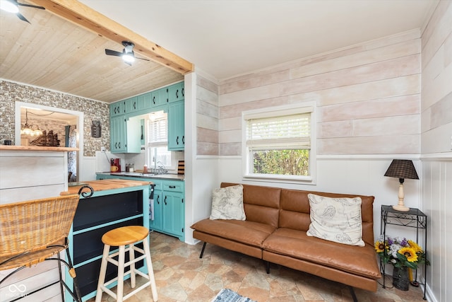 interior space with beamed ceiling, a wealth of natural light, wooden walls, and wooden ceiling