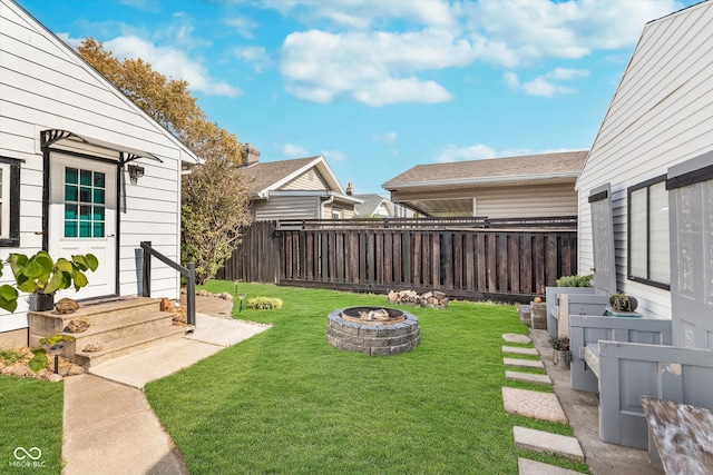 view of yard with a fire pit