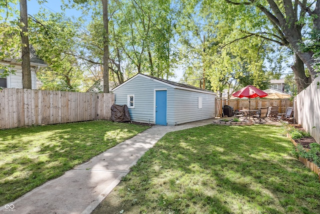 view of yard featuring a patio area and an outbuilding