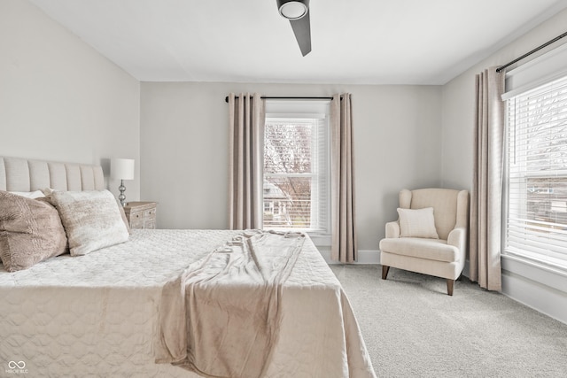 bedroom with multiple windows, ceiling fan, and carpet floors