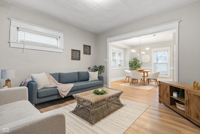 living room with hardwood / wood-style floors and an inviting chandelier