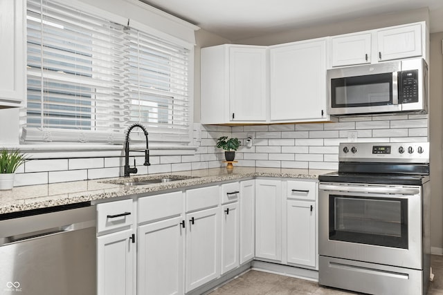 kitchen with white cabinets, sink, and stainless steel appliances