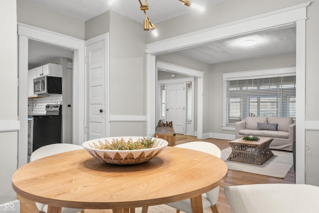 dining room with wood-type flooring