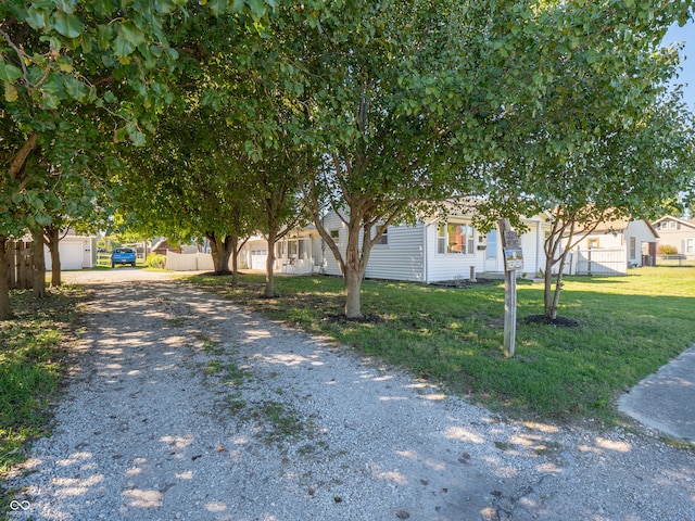 obstructed view of property featuring a front lawn