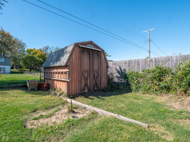 view of outbuilding with a yard