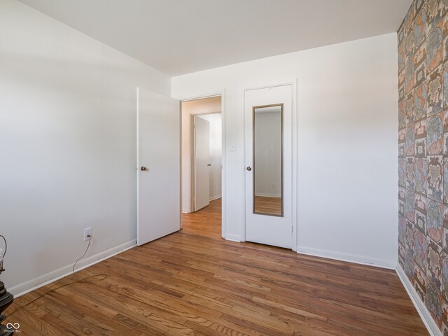 empty room with hardwood / wood-style flooring