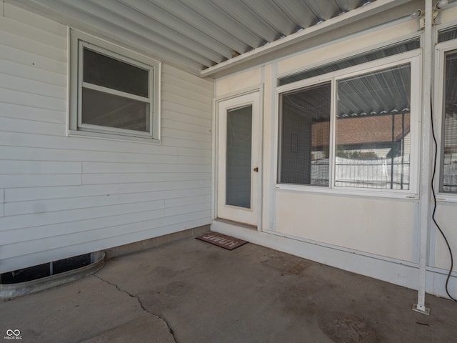 view of exterior entry featuring a patio area