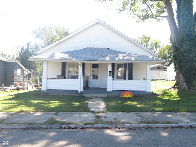 bungalow-style home with a front yard and a porch