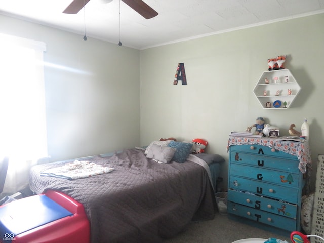 carpeted bedroom featuring ornamental molding and ceiling fan