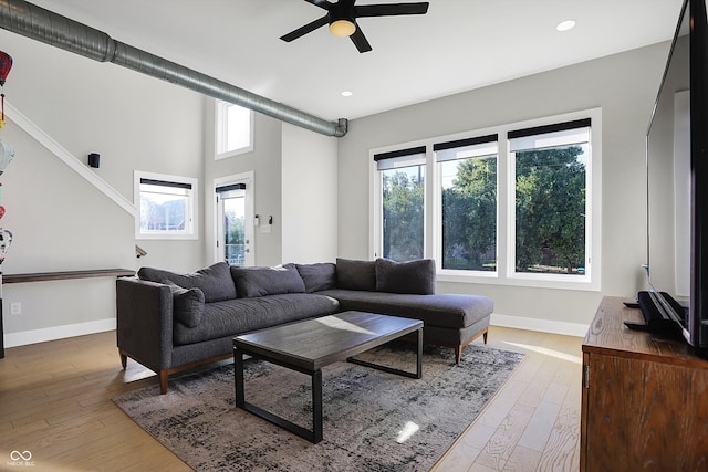 living room with wood-type flooring and ceiling fan