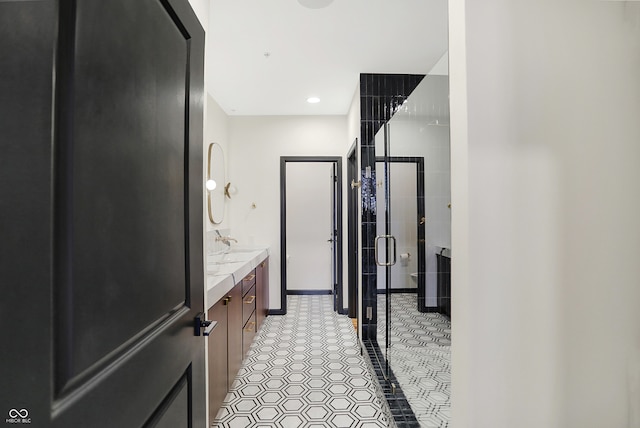 bathroom with walk in shower and vanity