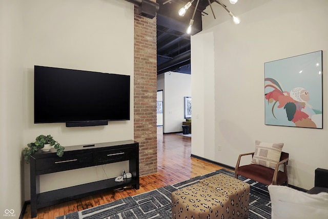 living room featuring wood-type flooring and an inviting chandelier