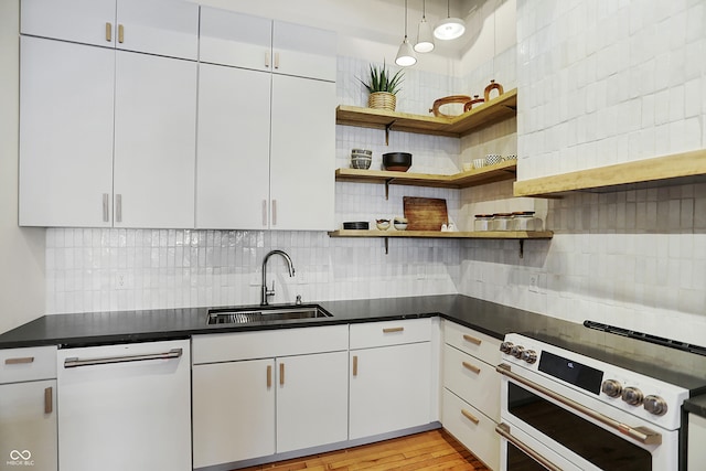 kitchen featuring white cabinetry, tasteful backsplash, white appliances, light hardwood / wood-style flooring, and sink