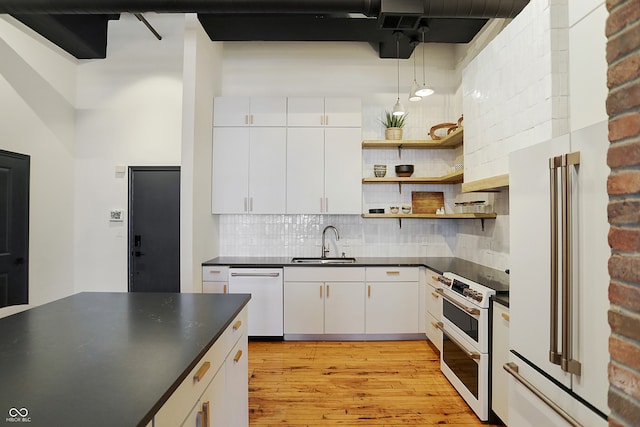 kitchen featuring light hardwood / wood-style floors, white cabinetry, tasteful backsplash, white appliances, and sink