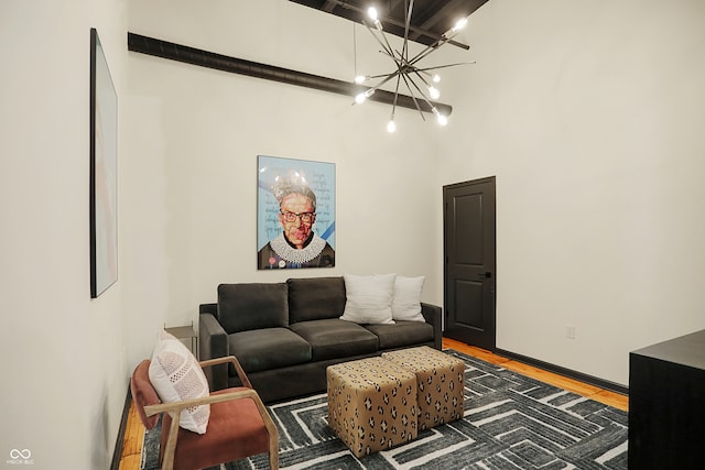 living room featuring a notable chandelier, a high ceiling, and dark hardwood / wood-style flooring