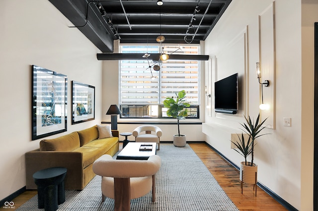 living room with hardwood / wood-style flooring and a high ceiling