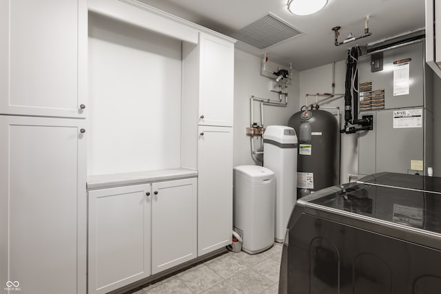 utility room with heating unit and washing machine and clothes dryer