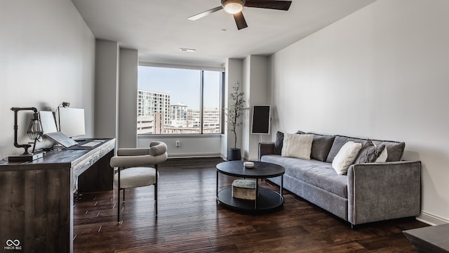 living room featuring dark hardwood / wood-style flooring and ceiling fan