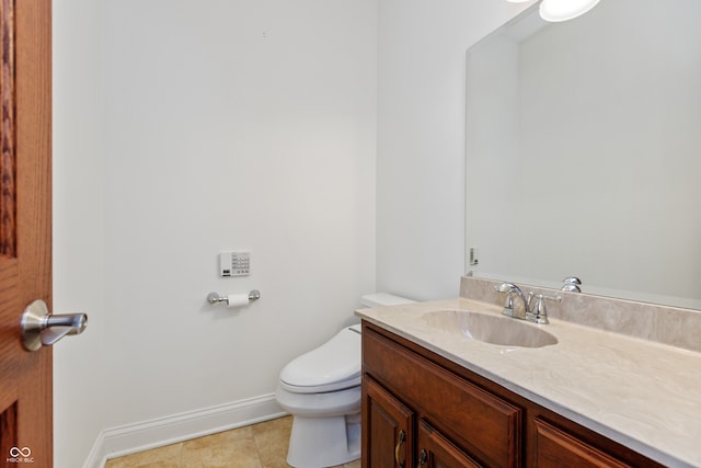 bathroom featuring vanity, toilet, and tile patterned flooring