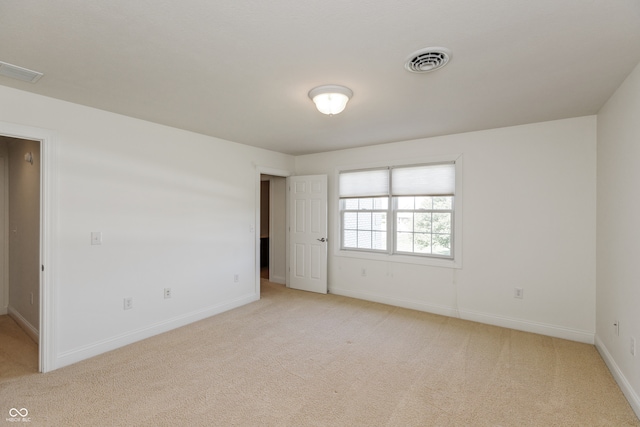 empty room featuring light carpet