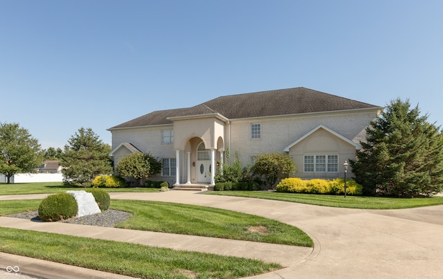 mediterranean / spanish home with a front yard