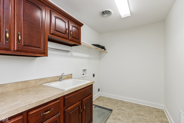 washroom with cabinets, sink, washer hookup, and electric dryer hookup