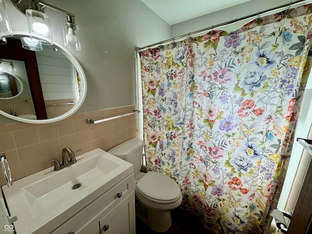 bathroom featuring tile walls, vanity, toilet, and a shower with curtain