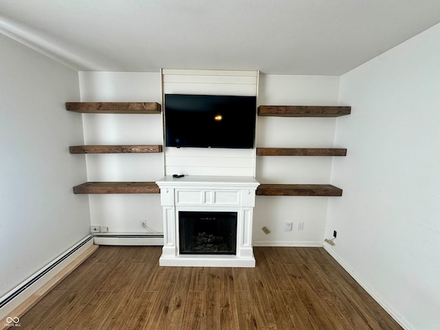 unfurnished living room with baseboard heating and dark wood-type flooring