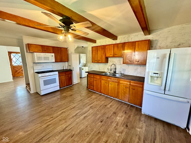 kitchen with sink, beam ceiling, white appliances, hardwood / wood-style floors, and ceiling fan