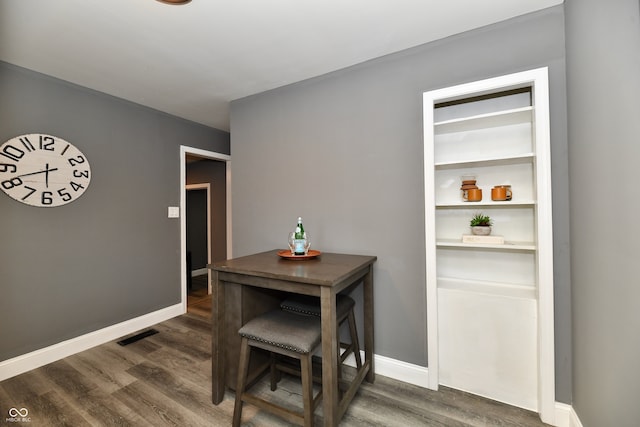 dining room with dark hardwood / wood-style flooring