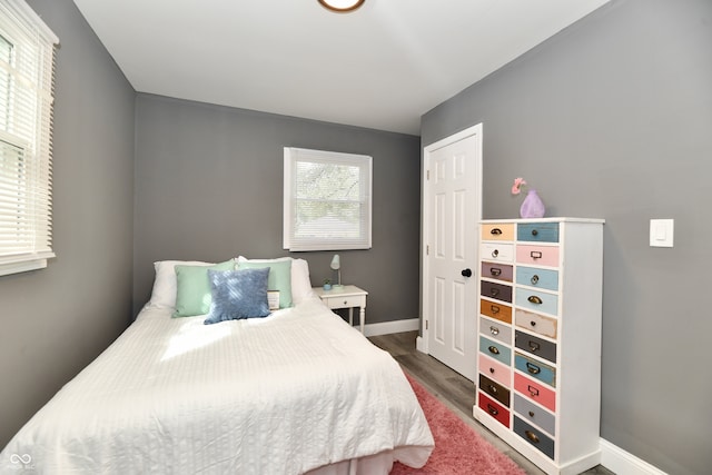 bedroom with dark hardwood / wood-style flooring