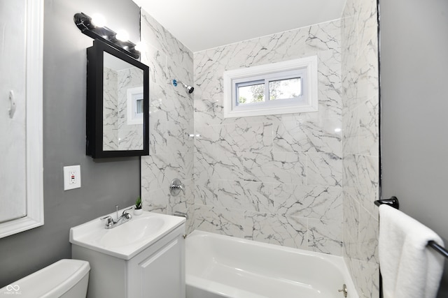 full bathroom with vanity, toilet, and tiled shower / bath