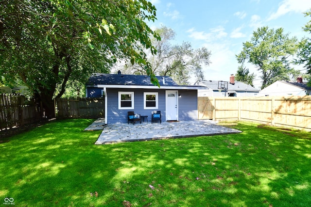 rear view of property with a lawn and a patio