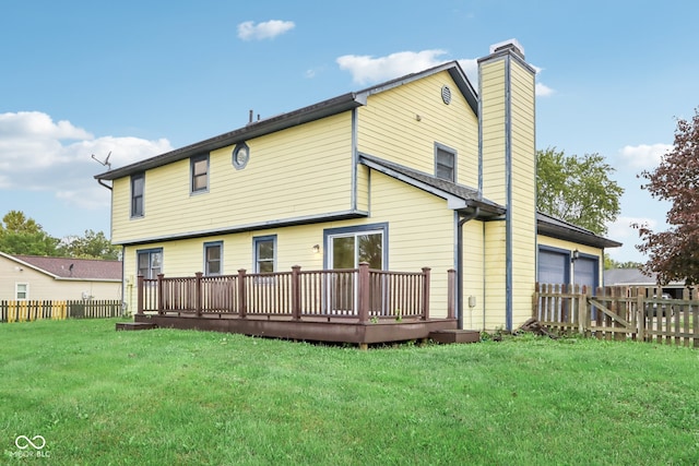 rear view of property with a lawn and a deck