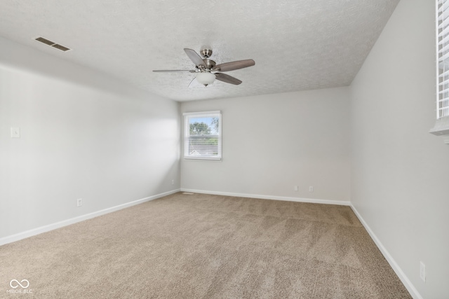 unfurnished room featuring ceiling fan, a textured ceiling, and carpet flooring