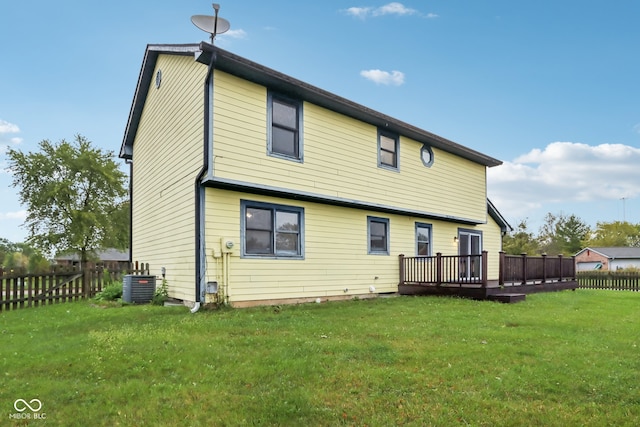 rear view of house featuring a lawn, cooling unit, and a deck