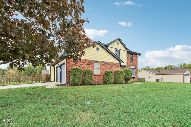 view of side of property featuring a garage and a lawn