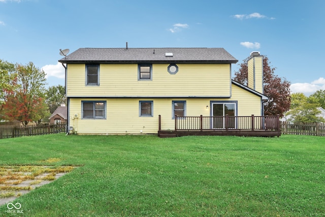 back of house featuring a yard and a deck