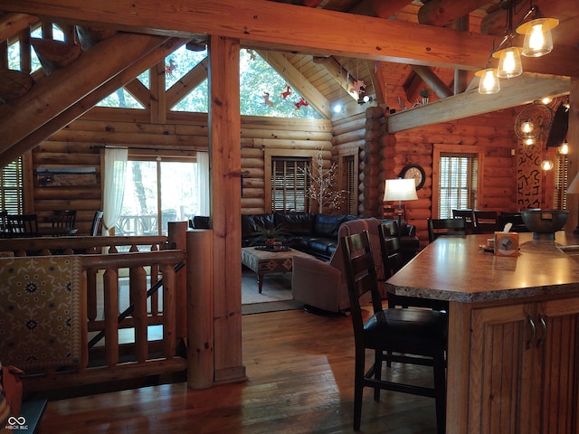 dining space featuring beamed ceiling, dark wood-type flooring, rustic walls, and high vaulted ceiling