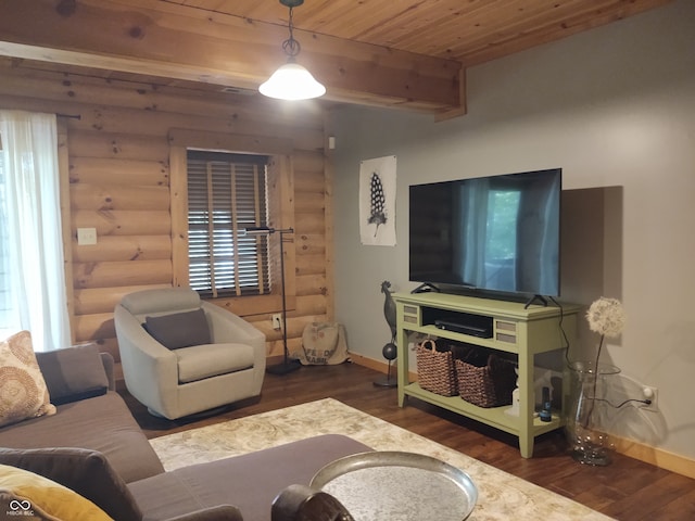 living room with a healthy amount of sunlight, dark hardwood / wood-style flooring, and rustic walls